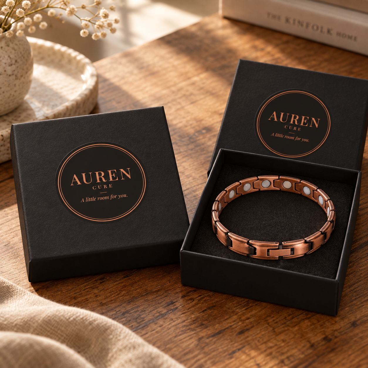 Two gift boxes, one displaying a narrow linked copper anklet